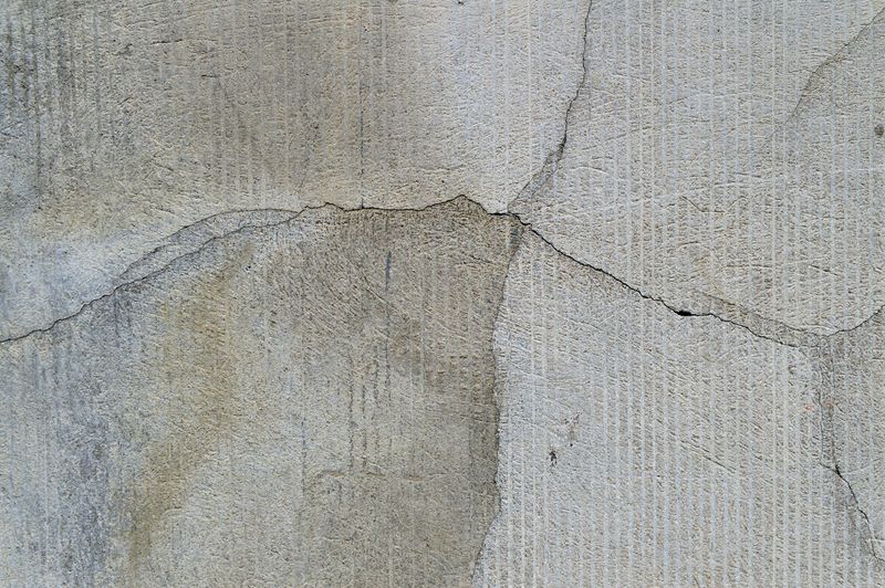 Crack running through textured concrete foundation